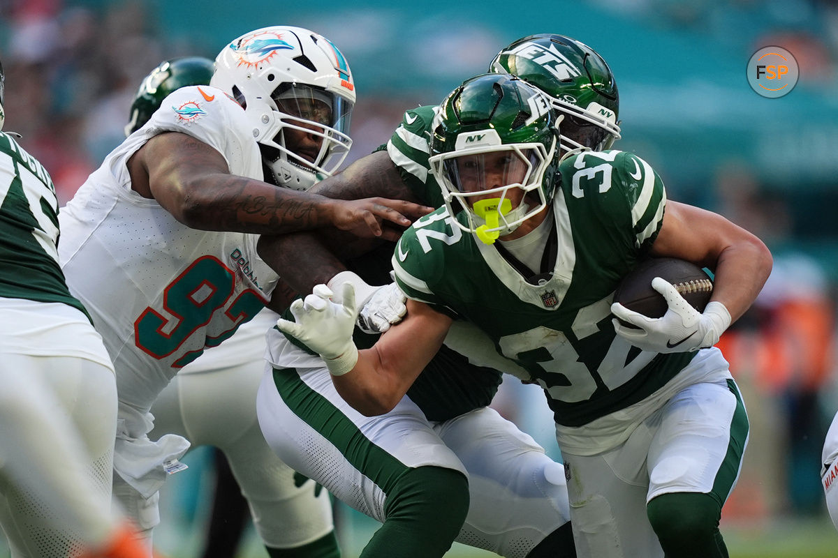 Dec 8, 2024; Miami Gardens, Florida, USA; New York Jets running back Isaiah Davis (32) rushes with the bal for a touchdown against the Miami Dolphins  during the first half at Hard Rock Stadium. Credit: Jasen Vinlove-Imagn Images