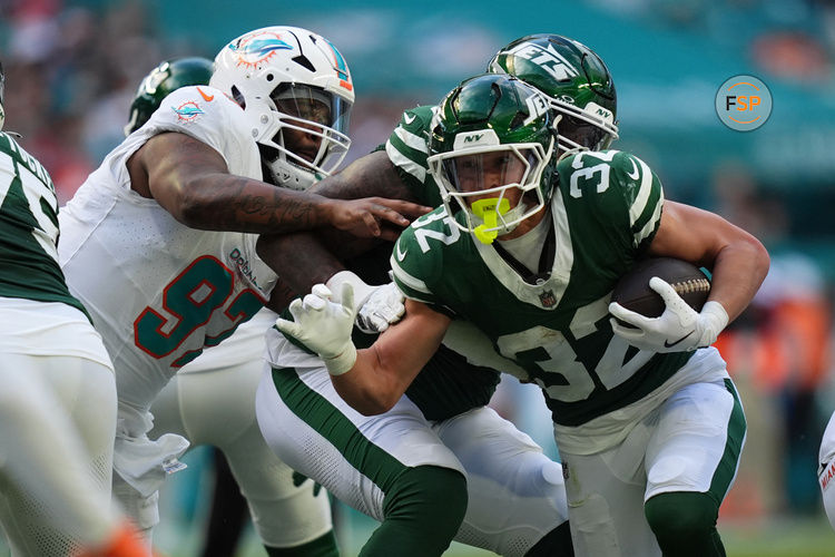 Dec 8, 2024; Miami Gardens, Florida, USA; New York Jets running back Isaiah Davis (32) rushes with the bal for a touchdown against the Miami Dolphins  during the first half at Hard Rock Stadium. Credit: Jasen Vinlove-Imagn Images