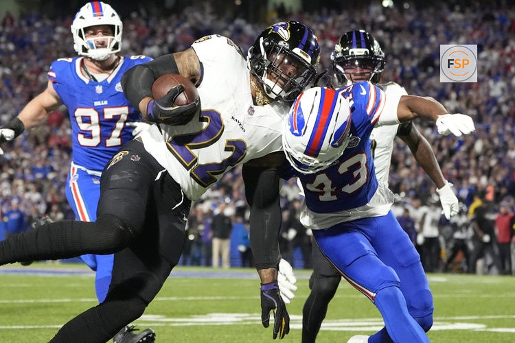 Sep 7, 2025; Orchard Park, New York, USA; Baltimore Ravens running back Derrick Henry (22) runs the ball during the second quarter against Buffalo Bills cornerback Dorian Strong (43) at Highmark Stadium. Credit: Gregory Fisher-Imagn Images