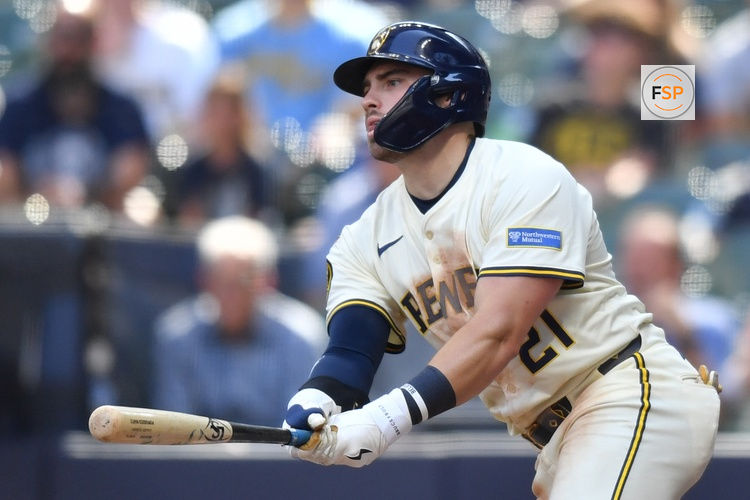 Jul 9, 2025; Milwaukee, Wisconsin, USA; Milwaukee Brewers third baseman Caleb Durbin (21) hits a single during the ninth inning against the Los Angeles Dodgers at American Family Field. Credit: Patrick Gorski-Imagn Images