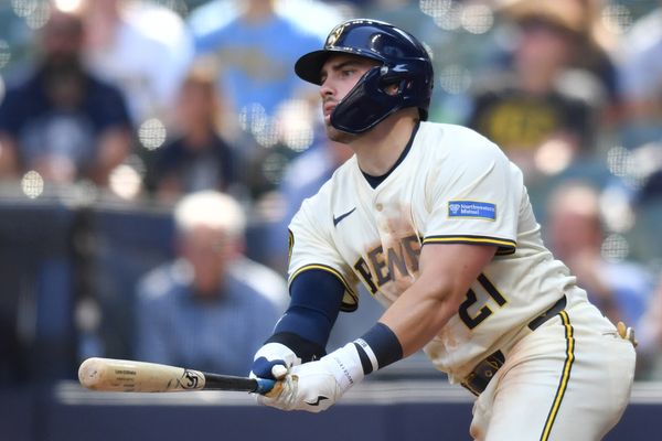 Jul 9, 2025; Milwaukee, Wisconsin, USA; Milwaukee Brewers third baseman Caleb Durbin (21) hits a single during the ninth inning against the Los Angeles Dodgers at American Family Field. Mandatory Credit: Patrick Gorski-Imagn Images