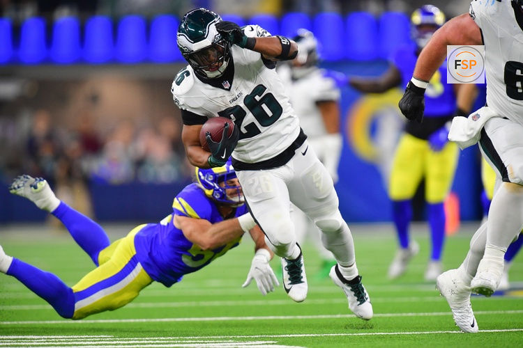 Nov 24, 2024; Inglewood, California, USA; Philadelphia Eagles running back Saquon Barkley (26) runs the ball ahead of Los Angeles Rams linebacker Christian Rozeboom (56) during the second half at SoFi Stadium. Credit: Gary A. Vasquez-Imagn Images