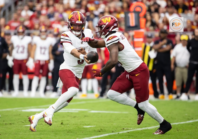 Sep 29, 2024; Glendale, Arizona, USA; Washington Commanders quarterback Jayden Daniels (5) hands off the ball to running back Brian Robinson Jr. (8) against the Arizona Cardinals in the first half at State Farm Stadium. Credit: Mark J. Rebilas-Imagn Images