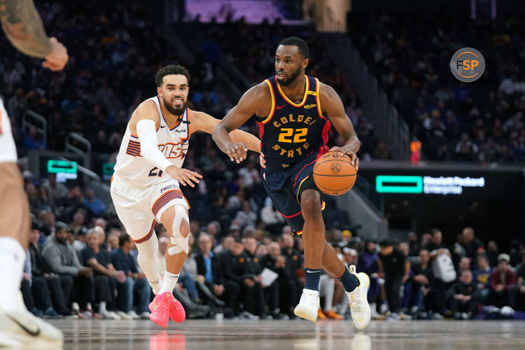 Jan 31, 2025; San Francisco, California, USA; Golden State Warriors forward Andrew Wiggins (22) dribbles past Phoenix Suns guard Tyus Jones (21) in the fourth quarter at the Chase Center. Credit: Cary Edmondson-Imagn Images