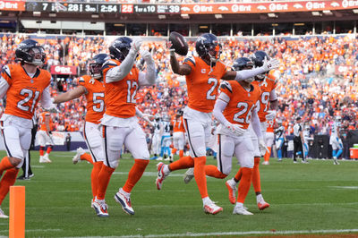 Oct 27, 2024; Denver, Colorado, USA; Denver Broncos cornerback Pat Surtain II (2) celebrates his interception with linebacker Kwon Alexander (12) and cornerback Riley Moss (21) and safety Devon Key (26) in the second half against the Carolina Panthers at Empower Field at Mile High. Mandatory Credit: Ron Chenoy-Imagn Images