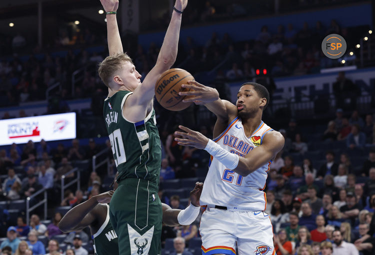 Feb 3, 2025; Oklahoma City, Oklahoma, USA; Oklahoma City Thunder guard Aaron Wiggins (21) passes around Milwaukee Bucks guard AJ Green (20) during the second half at Paycom Center. Credit: Alonzo Adams-Imagn Images