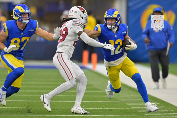 Jan 4, 2026; Inglewood, California, USA; Los Angeles Rams wide receiver Puka Nacua (12) runs after the catch as Arizona Cardinals cornerback Denzel Burke (29) defends during the second half at SoFi Stadium. Credit: Jayne Kamin-Oncea-Imagn Images