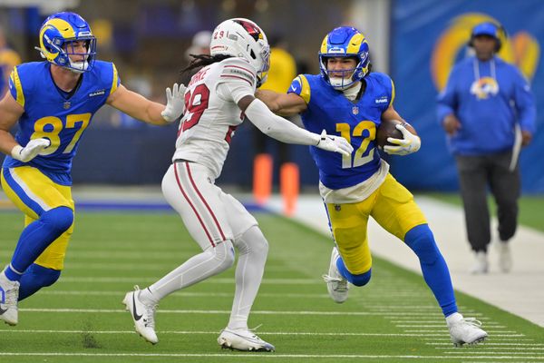 Jan 4, 2026; Inglewood, California, USA; Los Angeles Rams wide receiver Puka Nacua (12) runs after the catch as Arizona Cardinals cornerback Denzel Burke (29) defends during the second half at SoFi Stadium. Mandatory Credit: Jayne Kamin-Oncea-Imagn Images