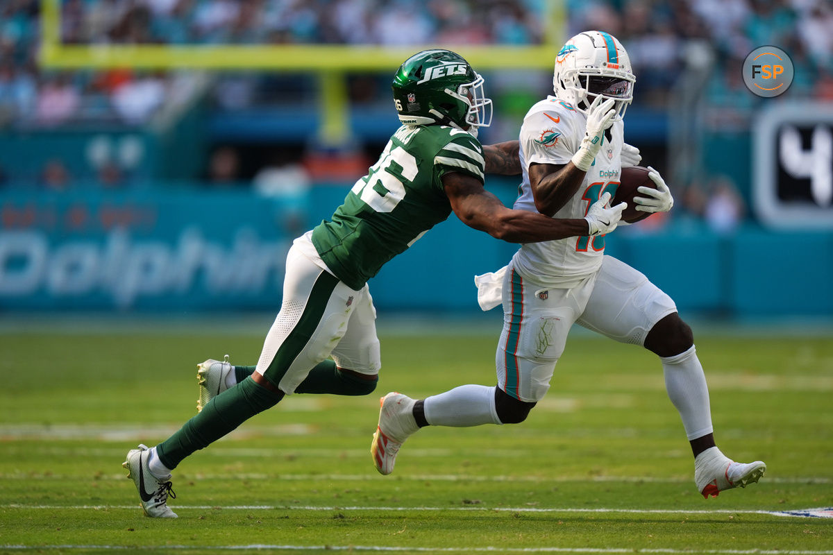 Dec 8, 2024; Miami Gardens, Florida, USA; New York Jets cornerback Brandin Echols (26) attempts to tackle Miami Dolphins wide receiver Tyreek Hill (10) during the first half at Hard Rock Stadium. Credit: Jasen Vinlove-Imagn Images