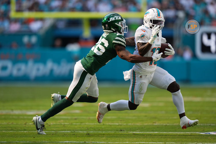 Dec 8, 2024; Miami Gardens, Florida, USA; New York Jets cornerback Brandin Echols (26) attempts to tackle Miami Dolphins wide receiver Tyreek Hill (10) during the first half at Hard Rock Stadium. Credit: Jasen Vinlove-Imagn Images