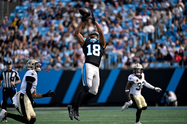 Nov 3, 2024; Charlotte, North Carolina, USA; Carolina Panthers wide receiver Jalen Coker (18) catches the ball as New Orleans Saints cornerback Alontae Taylor (1) defends in the first qarter at Bank of America Stadium. Mandatory Credit: Bob Donnan-Imagn Images