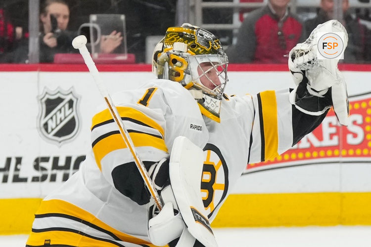 Apr 7, 2026; Raleigh, North Carolina, USA;  Boston Bruins goaltender Jeremy Swayman (1) makes a glove save against the Carolina Hurricanes during the first period at Lenovo Center. Credit: James Guillory-Imagn Images