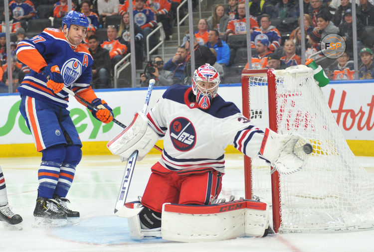 Dec 31, 2018; Edmonton, Alberta, CAN; Edmonton Oilers left winger Milan Lucic (27) looks on as Winnipeg Jets goalie Connor Hellebuck (37) makes a save during the second period at Rogers Place.  Credit: Walter Tychnowicz-USA TODAY Sports
