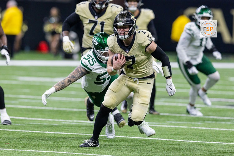 Dec 21, 2025; New Orleans, Louisiana, USA;  New Orleans Saints tight end Taysom Hill (7) runs away from the tackle of New York Jets defensive end Braiden McGregor (55) during the second half  at Caesars Superdome. Credit: Stephen Lew-Imagn Images