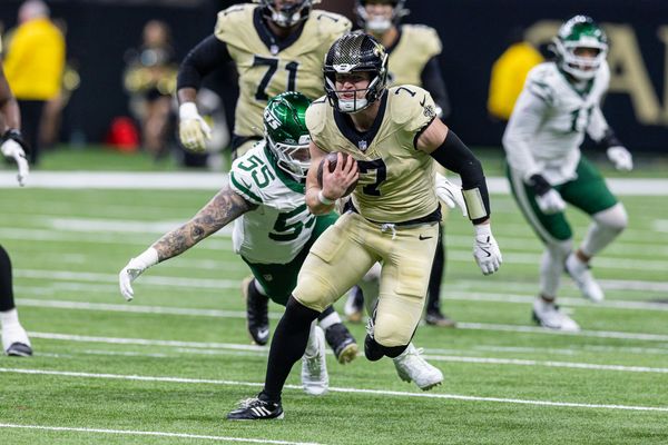 Dec 21, 2025; New Orleans, Louisiana, USA;  New Orleans Saints tight end Taysom Hill (7) runs away from the tackle of New York Jets defensive end Braiden McGregor (55) during the second half  at Caesars Superdome. Mandatory Credit: Stephen Lew-Imagn Images