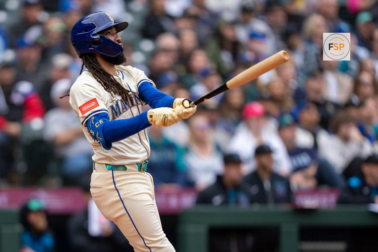 Apr 27, 2025; Seattle, Washington, USA;  Seattle Mariners shortstop J.P. Crawford (3) hits a home run against the Miami Marlins at T-Mobile Park. Credit: Stephen Brashear-Imagn Images