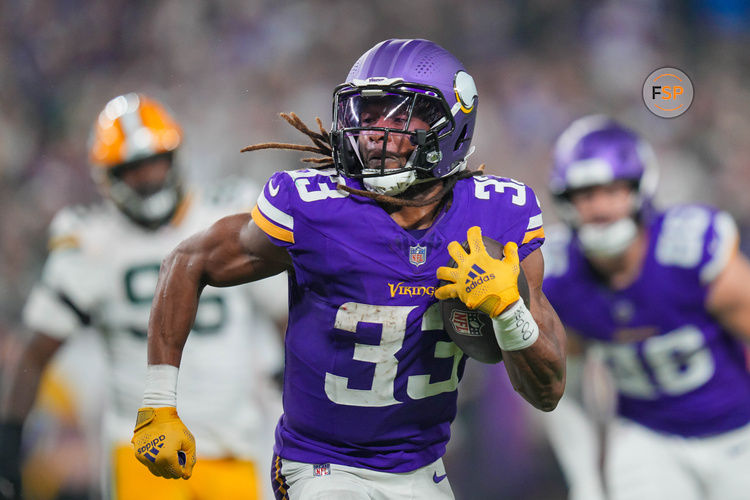 Dec 29, 2024; Minneapolis, Minnesota, USA; Minnesota Vikings running back Aaron Jones (33) runs with the ball against Green Bay Packers in the third quarter at U.S. Bank Stadium. Credit: Brad Rempel-Imagn Images