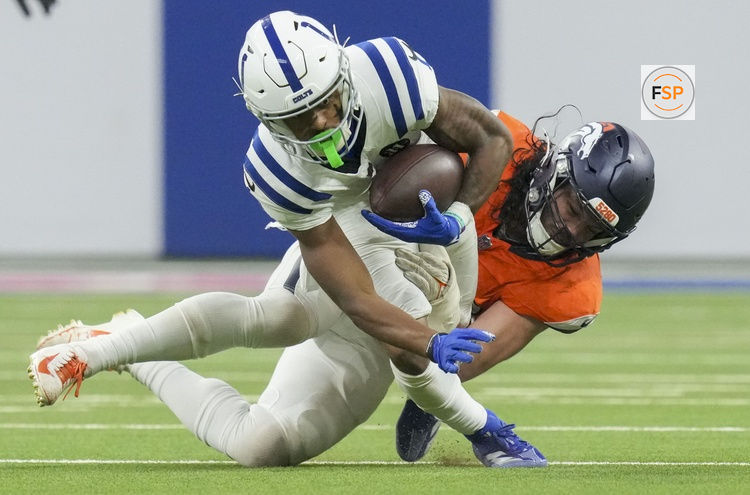 Sep 14, 2025; Indianapolis, Indiana, USA; Denver Broncos linebacker Alex Singleton (49) tackles Indianapolis Colts wide receiver Josh Downs (1) at Lucas Oil Stadium. Credit: INDIANAPOLIS STAR-USA TODAY Network via Imagn Images