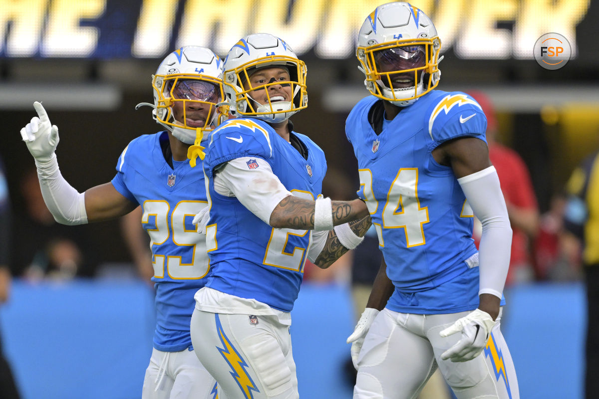 Dec 15, 2024; Inglewood, California, USA;  Los Angeles Chargers cornerback Elijah Molden (22) celebrates with cornerback Tarheeb Still (29) and defensive tackle Scott Matlock (44) after a fumble recovery in the first half against the Tampa Bay Buccaneers at SoFi Stadium. Credit: Jayne Kamin-Oncea-Imagn Images