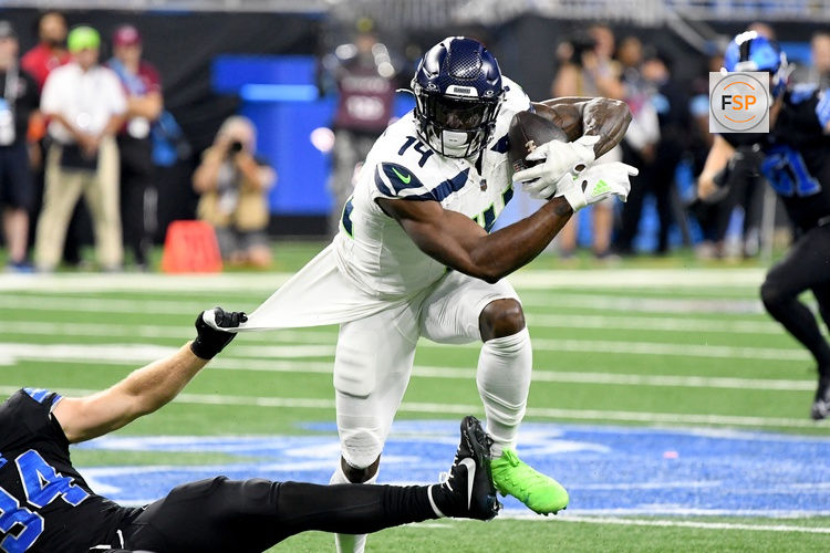 Sep 30, 2024; Detroit, Michigan, USA; Seattle Seahawks wide receiver DK Metcalf attempts to break a tackle from Detroit Lions linebacker Alex Anzalone (34) in the first quarter at Ford Field. Credit: Eamon Horwedel-Imagn Images