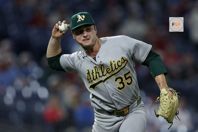 May 7, 2026; Philadelphia, Pennsylvania, USA; Athletics pitcher J.T. Ginn (35) is unable to throw out Philadelphia Phillies center fielder Justin Crawford (not pictured) on his single during the eighth inning at Citizens Bank Park. Credit: Bill Streicher-Imagn Images