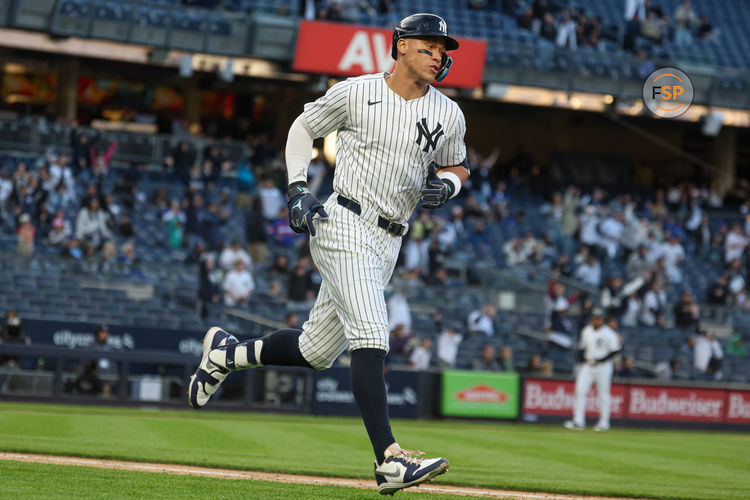 Apr 27, 2025; Bronx, New York, USA;  New York Yankees right fielder Aaron Judge (99) hits a solo home run during the sixth inning against the Toronto Blue Jays at Yankee Stadium. Credit: Vincent Carchietta-Imagn Images