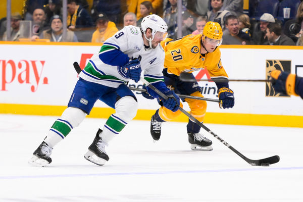 Jan 29, 2025; Nashville, Tennessee, USA;   Vancouver Canucks center J.T. Miller (9) skates with the puck against the Nashville Predators during the second period at Bridgestone Arena. Mandatory Credit: Steve Roberts-Imagn Images