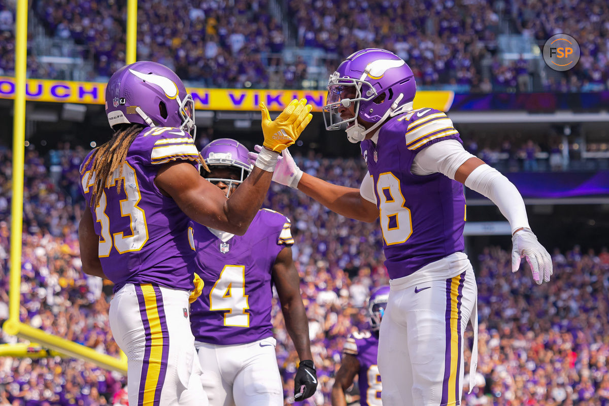 Sep 22, 2024; Minneapolis, Minnesota, USA; Minnesota Vikings running back Aaron Jones (33) celebrates his touchdown with wide receiver Justin Jefferson (18) against the Houston Texans in the first quarter at U.S. Bank Stadium. Credit: Brad Rempel-Imagn Images