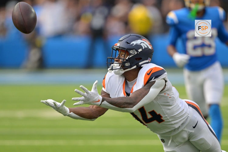 Sep 21, 2025; Inglewood, California, USA;  Denver Broncos wide receiver Courtland Sutton (14) reaches for a long pass 4th down in the second half against the Los Angeles Chargers at SoFi Stadium. Credit: Jayne Kamin-Oncea-Imagn Images