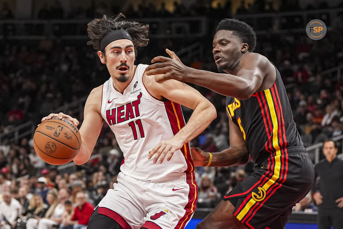 Dec 28, 2024; Atlanta, Georgia, USA; Miami Heat guard Jaime Jaquez Jr. (11) dribbles defended by Atlanta Hawks center Clint Capela (15) during the first half at State Farm Arena. Credit: Dale Zanine-Imagn Images