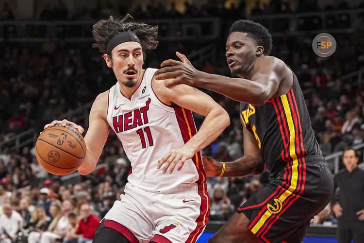 Dec 28, 2024; Atlanta, Georgia, USA; Miami Heat guard Jaime Jaquez Jr. (11) dribbles defended by Atlanta Hawks center Clint Capela (15) during the first half at State Farm Arena. Credit: Dale Zanine-Imagn Images