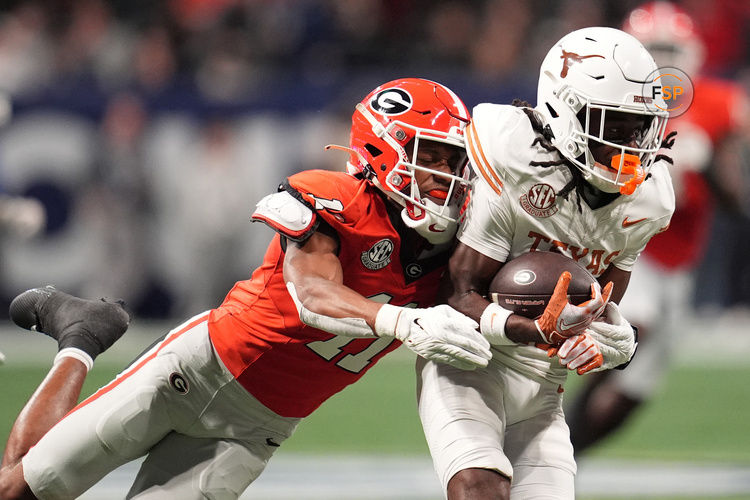 Dec 7, 2024; Atlanta, GA, USA; Texas Longhorns wide receiver Silas Bolden (11) makes a catch agaistn Georgia Bulldogs linebacker Jalon Walker (11) during the first half in the 2024 SEC Championship game at Mercedes-Benz Stadium. Credit: Dale Zanine-Imagn Images