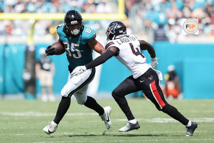 Sep 21, 2025; Jacksonville, Florida, USA; Jacksonville Jaguars tight end Brenton Strange (85) runs the ball against Houston Texans cornerback Kamari Lassiter (4) during the third quarter at EverBank Stadium. Credit: Morgan Tencza-Imagn Images