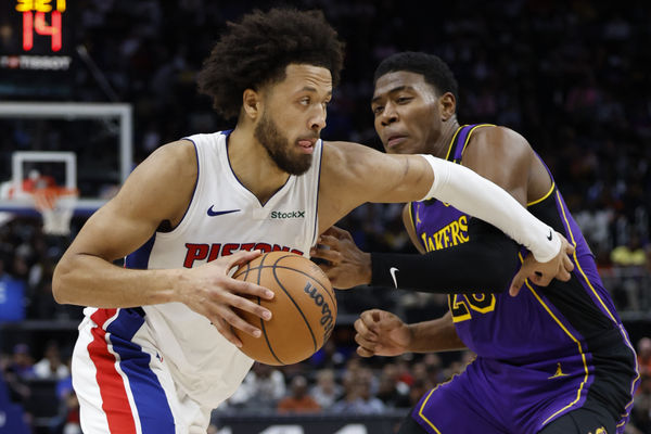 Nov 4, 2024; Detroit, Michigan, USA;  Detroit Pistons guard Cade Cunningham (2) dribbles defended by Los Angeles Lakers forward Rui Hachimura (28) in the second half at Little Caesars Arena. Mandatory Credit: Rick Osentoski-Imagn Images