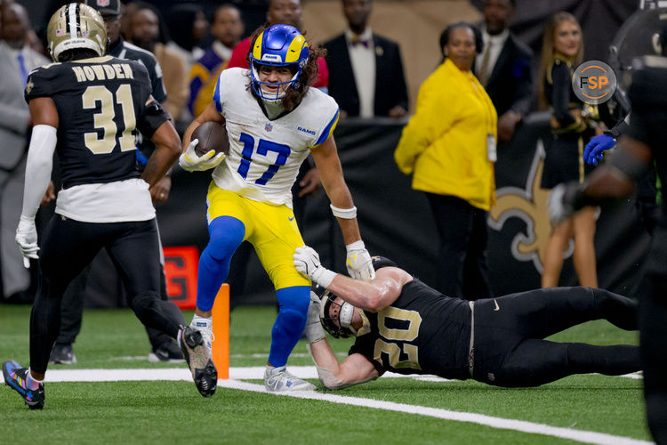 Dec 1, 2024; New Orleans, Louisiana, USA; Los Angeles Rams wide receiver Puka Nacua (17) scores a touchdown against New Orleans Saints linebacker Pete Werner (20) during the second half at Caesars Superdome. Credit: Matthew Hinton-Imagn Images