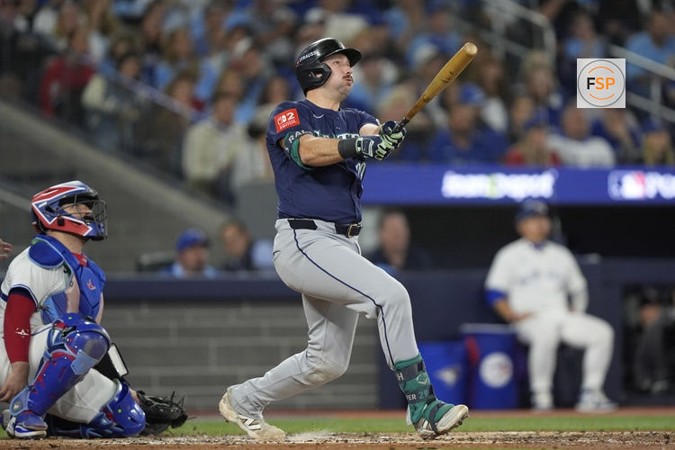Oct 20, 2025; Toronto, Ontario, CAN; Seattle Mariners catcher Cal Raleigh (29) hits a solo home run against the Toronto Blue Jays in the fifth inning during game seven of the ALCS round for the 2025 MLB playoffs at Rogers Centre. Credit: John E. Sokolowski-Imagn Images