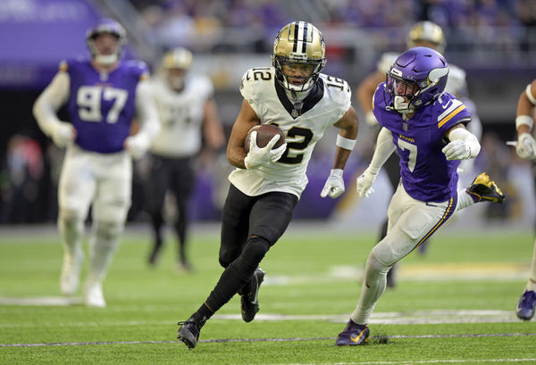 MINNEAPOLIS, MN - NOVEMBER 12: New Orleans Saints wide receiver Chris Olave (12) runs with the ball as Minnesota Vikings defensive back Byron Murphy (7) gives chase during an NFL game between the Minnesota Vikings and New Orleans Saints on November 12, 2023, at U.S. Bank Stadium in Minneapolis, MN. (Photo by Nick Wosika/Icon Sportswire)