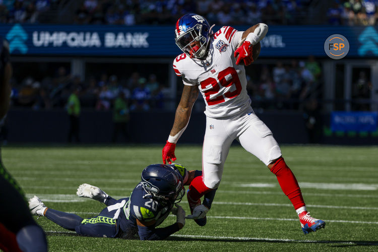 Oct 6, 2024; Seattle, Washington, USA; New York Giants running back Tyrone Tracy Jr. (29) breaks a tackle attempt by Seattle Seahawks safety Julian Love (20) during the second quarter at Lumen Field. Credit: Joe Nicholson-Imagn Images