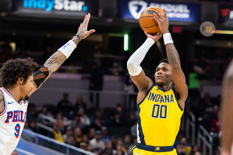 Jan 18, 2025; Indianapolis, Indiana, USA; Indiana Pacers guard Bennedict Mathurin (00) shoots the ball while Philadelphia 76ers guard Kelly Oubre Jr. (9) defends in the first half at Gainbridge Fieldhouse. Credit: Trevor Ruszkowski-Imagn Images