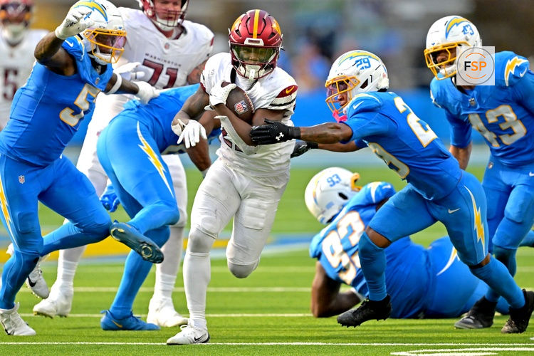 Oct 5, 2025; Inglewood, California, USA; Washington Commanders running back Jacory Croskey-Merritt (22) runs past Los Angeles Chargers defense at SoFi Stadium. Credit: Jayne Kamin-Oncea-Imagn Images