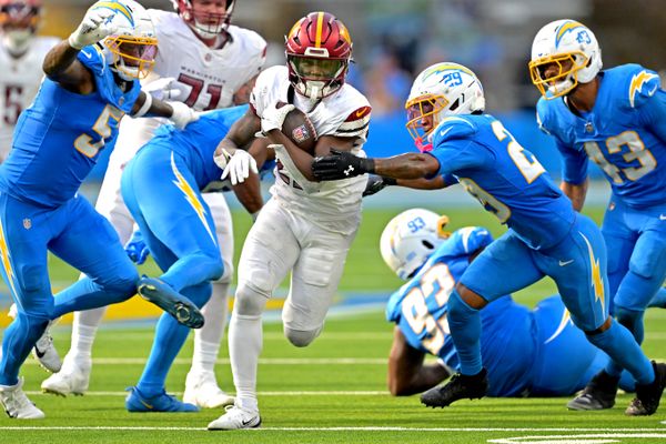Oct 5, 2025; Inglewood, California, USA; Washington Commanders running back Jacory Croskey-Merritt (22) runs past Los Angeles Chargers defense at SoFi Stadium. Mandatory Credit: Jayne Kamin-Oncea-Imagn Images