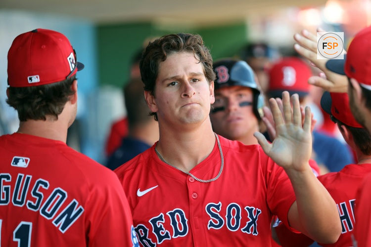 Feb 28, 2025; Clearwater, Florida, USA; Boston Red Sox outfielder Roman Anthony (48) is congratulated after he scored a run against the Philadelphia Phillies  during the third inning  at BayCare Ballpark. Credit: Kim Klement Neitzel-Imagn Images