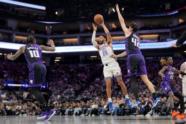 Nov 7, 2025; Sacramento, California, USA; Oklahoma City Thunder guard Ajay Mitchell (25) passes the ball away from the reach of Sacramento Kings center Maxime Raynaud (42) in the fourth quarter at the Golden 1 Center. Mandatory Credit: Cary Edmondson-Imagn Images