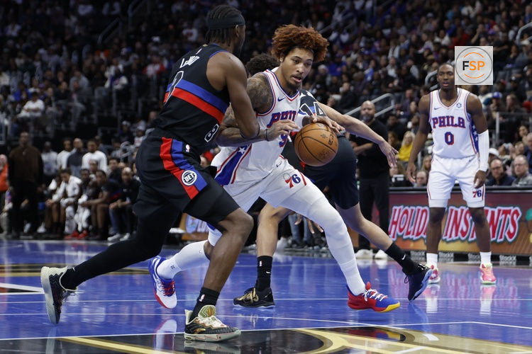 Nov 14, 2025; Detroit, Michigan, USA;  Philadelphia 76ers guard Kelly Oubre Jr. (9) dribbles defended by Detroit Pistons guard Caris LeVert (8) in the first half at Little Caesars Arena. Credit: Rick Osentoski-Imagn Images