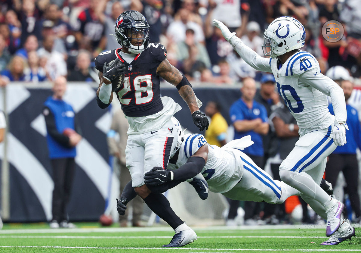 Oct 27, 2024; Houston, Texas, USA; Houston Texans running back Joe Mixon (28) runs with the ball as Indianapolis Colts linebacker E.J. Speed (45) attempts to make a tackle during the fourth quarter at NRG Stadium. Credit: Troy Taormina-Imagn Images