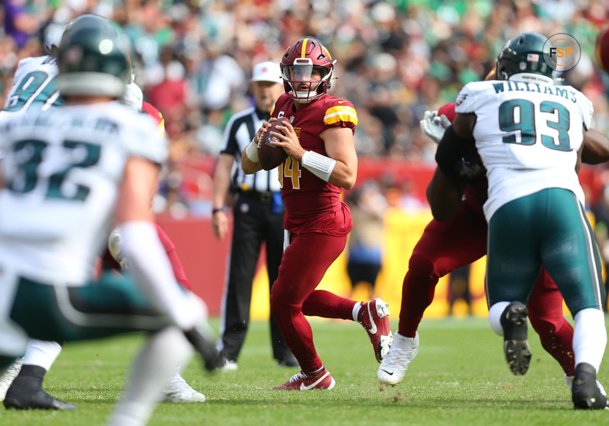 LANDOVER, MD - OCTOBER 29: Washington Commanders quarterback Sam Howell (14) surveys the field for an open receiver from the pocket while being pressured from Philadelphia Eagles defensive lineman Milton Williams (93)during the Philadelphia Eagles game versus the Washington Commanders on October 29, 2023, at FedEx Field in Landover, MD. (Photo by Lee Coleman/Icon Sportswire)