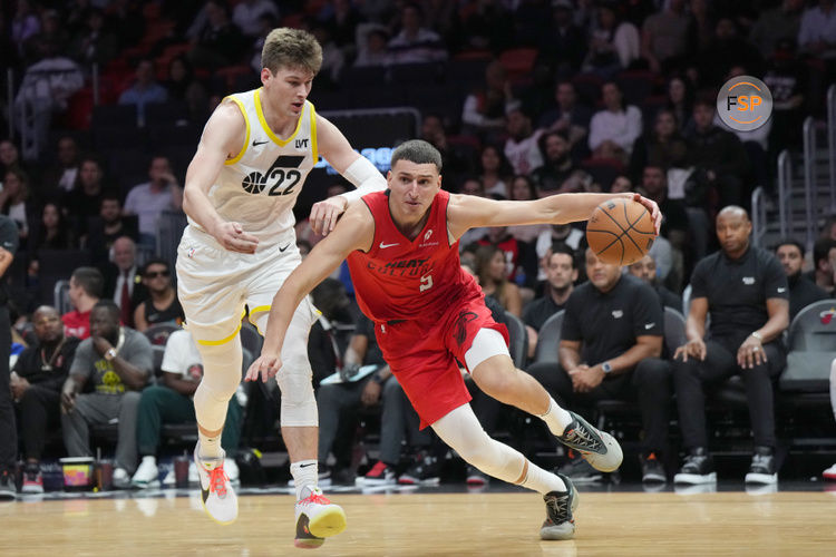 Jan 4, 2025; Miami, Florida, USA;  Miami Heat forward Nikola Jovic (5) drives past Utah Jazz forward Kyle Filipowski (22) during the second half at Kaseya Center. Credit: Jim Rassol-Imagn Images