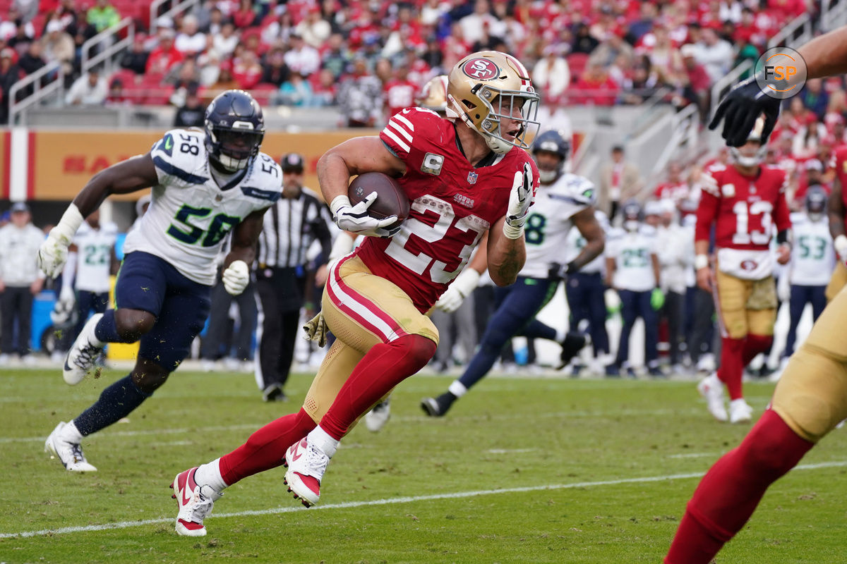 Nov 17, 2024; Santa Clara, California, USA; San Francisco 49ers running back Christian McCaffrey (23) rushes the ball while be pursued by Seattle Seahawks linebacker Derick Hall (58) in the fourth quarter at Levi's Stadium. Credit: David Gonzales-Imagn Images