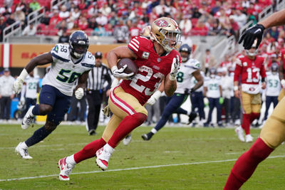 Nov 17, 2024; Santa Clara, California, USA; San Francisco 49ers running back Christian McCaffrey (23) rushes the ball while be pursued by Seattle Seahawks linebacker Derick Hall (58) in the fourth quarter at Levi's Stadium. Mandatory Credit: David Gonzales-Imagn Images