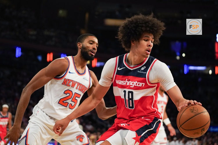 Nov 3, 2025; New York, New York, USA; Washington forward Kyshawn George (18) is defended by New York Knicks guard Mikal Bridges (25) during the second half at Madison Square Garden. Credit: Lucas Boland-Imagn Images